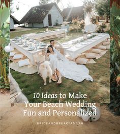 a bride and groom sitting on the grass with their dogs in front of an outdoor dining area