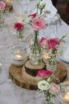 there are many vases with flowers in them sitting on the table at this wedding reception