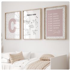 two framed pictures hang on the wall above a bed in a room with white walls