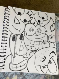 a drawing of some cartoon characters on a sheet of white paper with black marker markers