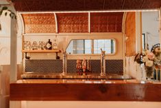 an old fashioned bar with flowers on the counter