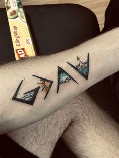 a man's arm with three triangles on it