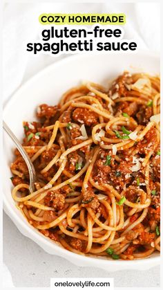 a white bowl filled with spaghetti and meat