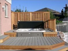 a hot tub sitting on top of a wooden deck