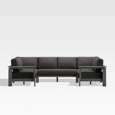 a black couch sitting on top of a white floor