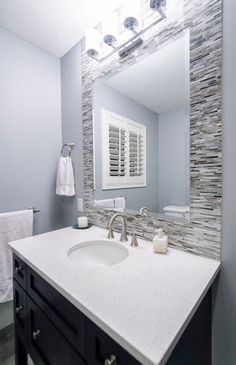 a white bathroom sink sitting under a mirror