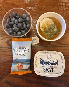 the ingredients to make blueberry cheesecakes are displayed on a wooden table top