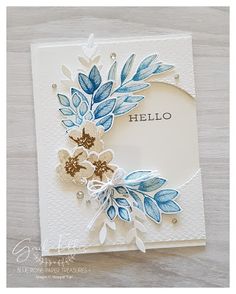 a handmade card with blue and white flowers on the front, and hello written on the back