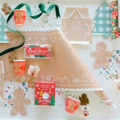 gingerbread cutouts and decorations on a table with green ribbon around the edges, along with candy