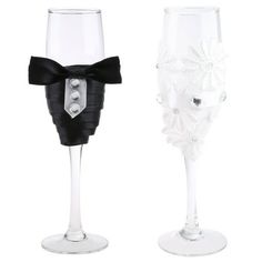 two wine glasses with black bows on them