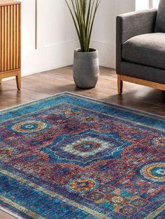 a living room area with a couch, chair and rug