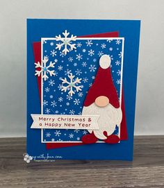 a christmas card with a santa clause on it and snowflakes in the background