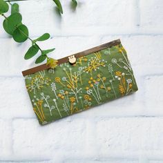 "Perfect gift for your special one! Classic embroidery floral metal frame Purse Wallet. A bi-fold clasp clutch wallet with a pull-through metal clasp. Handmade with premium embroider floral fabric as exterior and green color pure cotton as interior. Very neatly handmade. Each unit has 12 card slots, 1 zipper pocket and 2 bill pockets that will accommodate an iPhone plus in a case on either side. Toss it in your purse to double as a wallet. Perfect Gift for your wife, mom or special one for every Embroidered Wallets For Daily Use, Embroidered Wallets Perfect For Gifts, Elegant Green Clutch With Card Slots, Daily Use Embroidered Rectangular Wallet, Cloth Wallet, Cash Envelope Wallet, Classic Embroidery, Fabric Wallet, Frame Purse