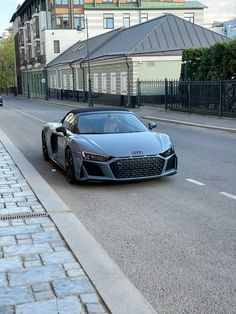 an audi sports car is parked on the side of the road