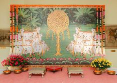 an elaborately decorated stage with flowers and vases