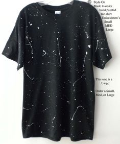 NEW fabric painted tee Black with white professional fabric paint  splatters.  Each one is one of a kind.  The manufacture of the original Tee shirt is Gildan, 100% Cotton. CUSTOM ORDER 3 to 5 days to ship.  Yours Will be similar to this, but no two are alike-hand painted.  PLEASE see Photo #3 for more to see size infoApprox. dimensions according to Gildan are as follows: **SMALL: Width is approx. 18 inches, Length is approx. 27 - 28 inches, Sleeve Center Back is approx. 15.5 inches **MEDIUM: Width is approx. 20 inches, Length is approx. 29 inches, Sleeve Center Back is approx. 17 inches **LARGE:Width is approx. 22 inches, Length is approx. 30 inches, Sleeve Center Back is approx. 18.5 inches Want a sweatshirt to match? https://www.etsy.com/listing/460192658/sweatshirt-star-sweatshirt-blac Distressed Tshirt Diy, Black Splash, White Tee Shirt, Black And White Tees, White Tee Shirts, Graphic Tee Shirt, Custom Sweatshirts, Shooting Stars, White Tee