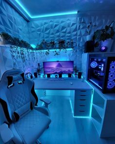 a room with a desk, chair and computer monitor on the wall is lit up by blue lights