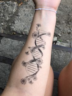 a woman's arm with a tattoo on it that shows a double - stranded structure