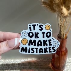 someone is holding up a sticker that says it's ok to make mistakes