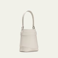 Givenchy "Shark Lock" bucket bag in leather  Features signature padlock accent  Flat top handle  Detachable chain crossbody strap  Open top  Approx. 5.5"H x 5.5"W x 2.7"D Made in Italy