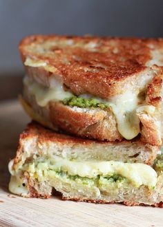 two grilled sandwiches with cheese and broccoli are stacked on top of each other