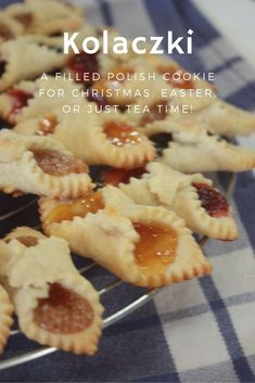 several small pastries on a cooling rack with the words kolaczki