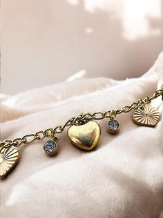 This beautiful bracelet, made from gold-colored stainless steel, features charming heart-shaped charms adorned with shimmering zircon stones. Its radiant design effortlessly combines elegance and romance, making it the perfect accessory to elevate any look. The sparkling zircon stones catch the light, adding a luxurious touch, while the heart charms symbolize love and affection. Whether you're looking for a meaningful gift or a stylish piece for yourself, this bracelet is a timeless addition to Heart Charm Bracelet, Charm Bracelets, Meaningful Gifts, Beautiful Bracelet, Heart Charm, Gold Color, Jewelry Collection, Jewelry Bracelets, Charm Bracelet