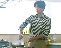 a man standing in a kitchen preparing food