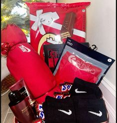 a basket filled with sports items next to a christmas tree