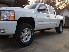 a white truck parked in front of a house