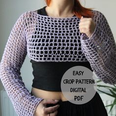 a woman with red hair wearing a black and white crochet cropped top