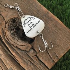 a metal fishing lure on a piece of wood with the words happy motorcyclist written on it