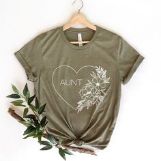 a t - shirt with the words,'aunt'written in white on it