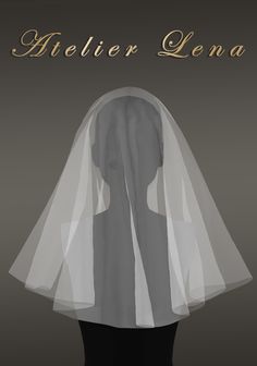 the back of a woman's head wearing a white veil with gold lettering on it