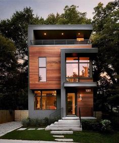 a modern house with stairs leading up to the second floor and two storyed windows