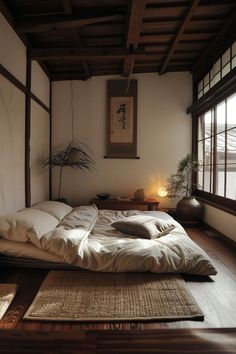 a bed with white sheets and pillows in a room next to two windows that have bamboo mats on them