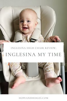 a baby sitting in a high chair holding a sign that says inglesina my time