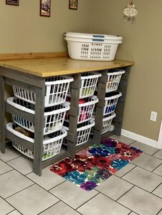 a kitchen island made out of crates with baskets underneath it and a rug on the floor