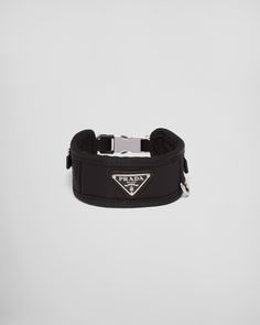 a black bracelet with a triangle logo on it