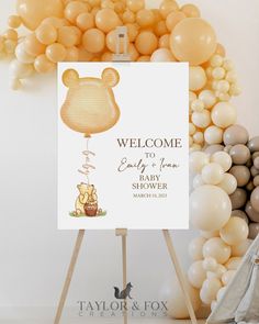 a welcome sign with winnie the pooh on it and balloons in the back ground