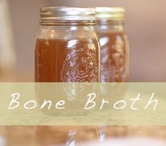 three jars filled with honey sitting on top of a table next to each other and the words bone broth above them