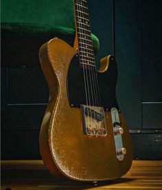 an electric guitar sitting on top of a wooden floor