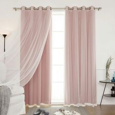 a living room with pink curtains and shoes on the floor