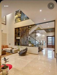 a living room filled with furniture and a staircase