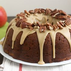 a bundt cake with pecans and caramel drizzle on top