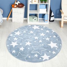 a blue rug with white stars on it in a child's playroom area