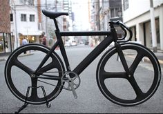 a black bicycle is parked on the street