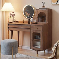 a desk with a mirror, stool and lamp next to it in a living room