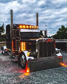 a large semi truck with its lights on