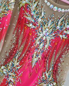 the back of a dress with beads and sequins on it